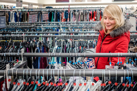 RIMOUSKI, CANADA - February 19, 2017. Woman Looking for Deals in a Winners Store in Rimouski, Quebec.のeditorial素材