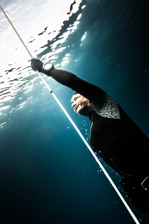 SAN ANDRES ISLAND, Colombia _ Circa March 2017. Freediver Diving and Following the Life Line at all time in the Deep Blue of San Andres Island, Colombia.のeditorial素材