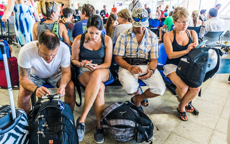 SAN ANDRES ISLAND, Colombia _ Circa March 2017. Few People With Tablets and Phones in the Waiting Room at the San Andres Airport.のeditorial素材