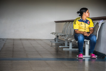 SAN ANDRES ISLAND, Colombia _ Circa March 2017. Colombian Woman Wearing the Country Soccer Shirt at the San Andres Airport... Waiting.のeditorial素材