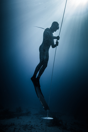 SAN ANDRES ISLAND, Colombia _ Circa March 2017. Freediver Diving and Following the Life Line at all time in the Deep Blue of San Andres Island, Colombia.のeditorial素材
