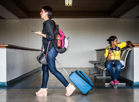 SAN ANDRES ISLAND, Colombia _ Circa March 2017. Woman with Luggage Walking in direction of her Flight at the San Andres Airport.のeditorial素材