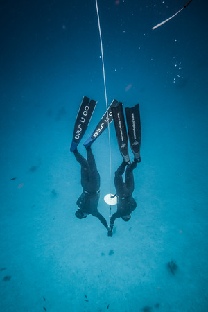 SAN ANDRES ISLAND, Colombia _ Circa March 2017. Freediver and his Safety Diver Diving and Following...