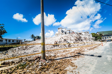 SAN ANDRES ISLAND, Colombia _ Circa March 2017. Destroyed Concrete Building near The Airport of San Andres with Employees Working at Cleaning the Zone.のeditorial素材