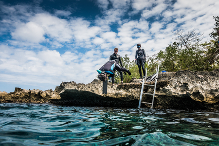 SAN ANDRES ISLAND, Colombia _ Circa March 2017. Group of Freedivers Getting into the Water from the Shore Line in San Andres Island.のeditorial素材