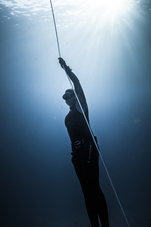 SAN ANDRES ISLAND, Colombia _ Circa March 2017. Freediver Diving and Following the Life Line at all time in the Deep Blue of San Andres Island, Colombia.のeditorial素材