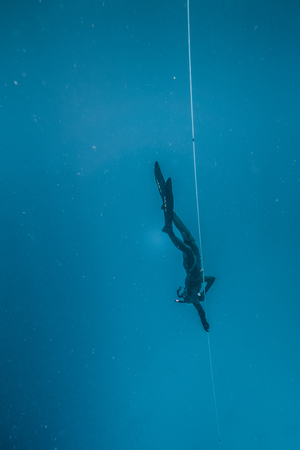 SAN ANDRES ISLAND, Colombia _ Circa March 2017. Freediver Diving and Following the Life Line at all time in the Deep Blue of San Andres Island, Colombia.のeditorial素材