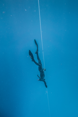 SAN ANDRES ISLAND, Colombia _ Circa March 2017. Freediver Diving and Following the Life Line at all time in the Deep Blue of San Andres Island, Colombia.のeditorial素材