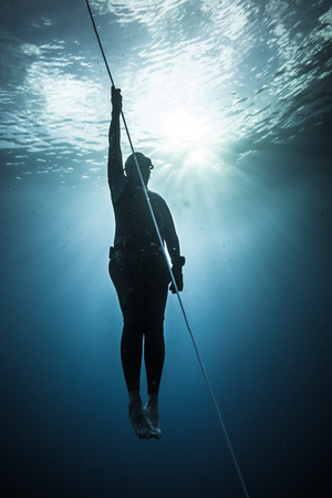 SAN ANDRES ISLAND, Colombia _ Circa March 2017. Freediver Diving and Following the Life Line at all time in the Deep Blue of San Andres Island, Colombia.のeditorial素材