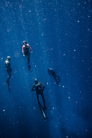 SAN ANDRES ISLAND, Colombia _ Circa March 2017. Freediver and his Safety Diver Diving and Following the Life Line at all time in the Deep Blue of San Andres Island, Colombia.のeditorial素材