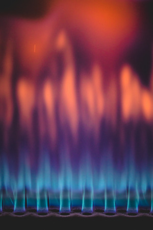 Close-up shot of beautiful blue and red colorful flame of burning gas in industrial heater