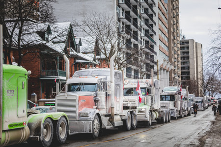 Ottawa, Ontario, Canada - January 29 2022. Convoy for Freedom 2022 Trucks and Tracors Protesting in the Streets with Flag and Signs.のeditorial素材