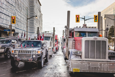 Ottawa, Ontario, Canada - January 29 2022. Convoy for Freedom 2022 Trucks and Tracors Protesting in the Streets with Flag and Signs.のeditorial素材