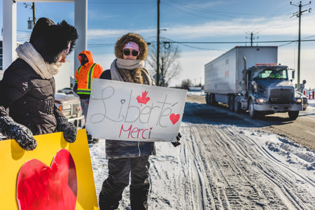 St Liboire, Quebec, Canada - January 28 2022. Protesters Supporting the Truckers Freedom Convoy 2022 with Free Food, Anti-Mandates Signs and Canadian Flags.のeditorial素材