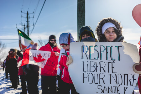 St Liboire, Quebec, Canada - January 28 2022. Protesters Supporting the Truckers Freedom Convoy 2022 with Free Food, Anti-Mandates Signs and Canadian Flags.のeditorial素材