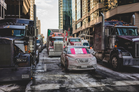 Ottawa, Ontario, Canada - January 31 2022. Car Stuck in the Convoy for Freedom 2022 Trucks and Tracors Protest in Ottawaのeditorial素材