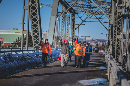 Ottawa, Ontario, Canada - January 29 2022. Protesters crossing the Ottawa Bridge to join the Freedom Convoy on the Parliament Hill on cold day of Winter.のeditorial素材