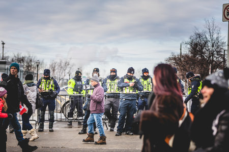 Ottawa, Ontario, Canada - January 30 2022. Police in Ottawa Convoy for Freedom 2022 and Protesters in the Streets.のeditorial素材