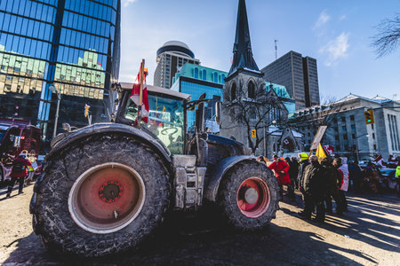Ottawa, Ontario, Canada - January 29 2022. Convoy for Freedom 2022 Farm Tracors Protesting in the Streets with Flag and Signs.のeditorial素材