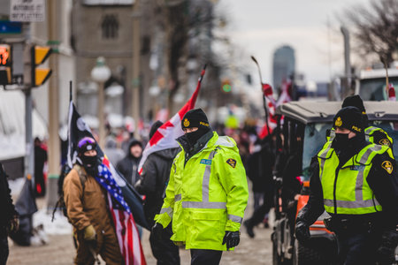 Ottawa, Ontario, Canada - January 30 2022. Police in Ottawa Convoy for Freedom 2022 and Protesters in the Streets.のeditorial素材