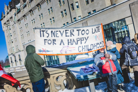 Ottawa, Ontario, Canada - January 29 2022. Protesters in Ottawa Convoy for Freedom 2022 Protesting in the Streets with Flag, Signs and Smiles.のeditorial素材