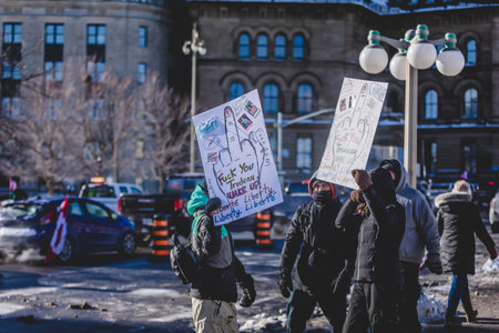 Ottawa, Ontario, Canada - January 29 2022. Protesters in Ottawa Convoy for Freedom 2022 Protesting in the Streets with Flag, Signs and Smiles.のeditorial素材