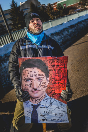 Ottawa, Ontario, Canada - January 29 2022. Protester in Ottawa Convoy for Freedom 2022 Protesting in the Streets with Trudeau Placardのeditorial素材