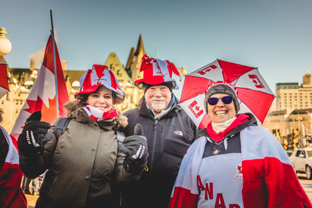 Ottawa, Ontario, Canada - January 29 2022. Protesters in Ottawa Convoy for Freedom 2022 Protesting in the Streets with Flag, Signs and Smiles.のeditorial素材