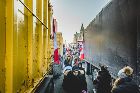 Ottawa, Ontario, Canada - January 29 2022. Trucks and Protesters in Ottawa Convoy for Freedom 2022 Protesting in the Streets with Flag, Signs and Smiles.のeditorial素材