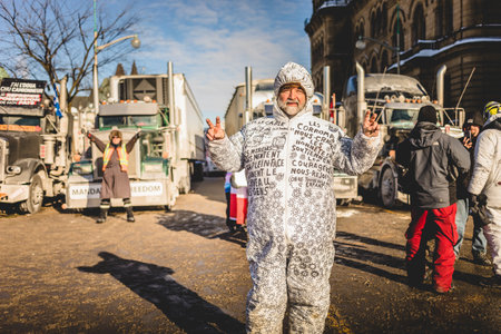 Ottawa, Ontario, Canada - January 30 2022. Protesters in Ottawa Convoy for Freedom 2022 Protesting in the Streets with handmade White Suitのeditorial素材