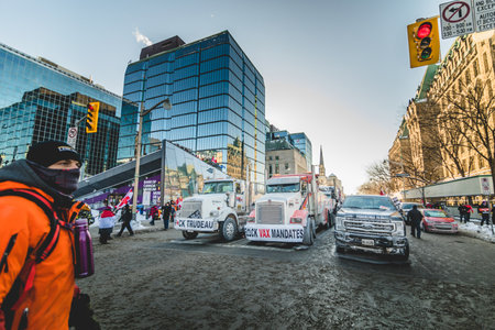 Ottawa, Ontario, Canada - January 29 2022. Convoy for Freedom 2022 Trucks and Tracors Protesting in the Streets with Flag and Signs.のeditorial素材