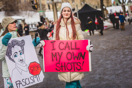 Ottawa, Ontario, Canada - January 30 2022. Protesters in Ottawa Convoy for Freedom 2022 Protesting in the Streets with Flag, Signs and Smiles.のeditorial素材