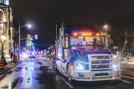 Ottawa, Ontario, Canada - February 10, 2022. Blocked Wellington Street with Trucks and Cars and many Protesters at Night During Freedom Convoy Protestのeditorial素材
