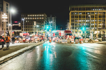 Ottawa, Ontario, Canada - February 11, 2022. Blocked Wellington Street with Trucks and Cars and many Protesters at Night.のeditorial素材