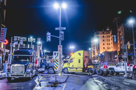 Ottawa, Ontario, Canada - February 11, 2022. Blocked Wellington Street with Trucks and Cars and many Protesters at Night.のeditorial素材