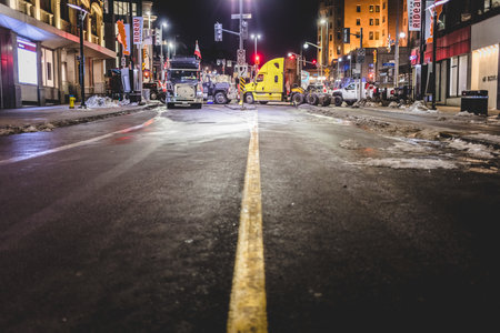 Ottawa, Ontario, Canada - February 10, 2022. Blocked Wellington Street with Trucks and Cars and many Protesters at Night.During Freedom Convoy Protestのeditorial素材