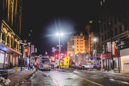 Ottawa, Ontario, Canada - February 11, 2022. Blocked Wellington Street with Trucks and Cars and many Protesters at Night.のeditorial素材