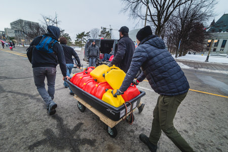 Ottawa, Ontario, Canada - February 11, 2022. People Transportin Diesel Jerry Cans during Freedom Convoy Protest in Ottawa.のeditorial素材