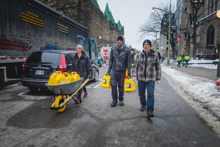 Ottawa, Ontario, Canada - February 11, 2022. People Transportin Diesel Jerry Cans during Freedom Convoy Protest in Ottawa.のeditorial素材