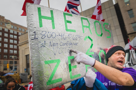 Ottawa, Ontario, Canada - February 11, 2022. Man and Woman Protesting with Massage about Jusin Trudeau During Freedom Convoy Protest in Ottawa.のeditorial素材