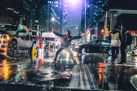 Ottawa, Ontario, Canada - February 11, 2022. Woman Protester Dancin in the Street at Night Under...