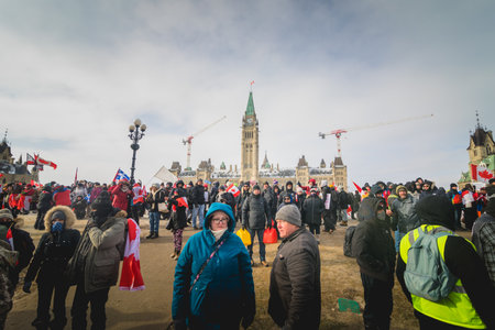 Ottawa, Ontario, Canada - February 12, 2022. Crowd of Protesters in Front of Parliament during Freedom Convoy Protest in Ottawa.のeditorial素材