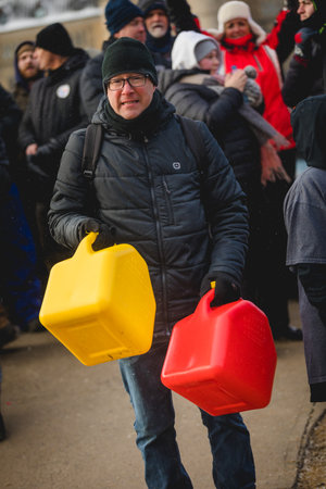 Ottawa, Ontario, Canada - February 12, 2022. Protester Hitting a Jerry Cans during Freedom Convoy...