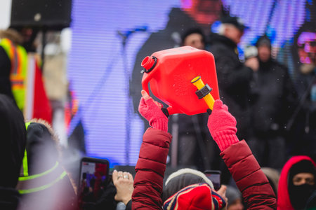 Ottawa, Ontario, Canada - February 12, 2022. Protester Hitting a Jerry Can during Freedom Convoy...