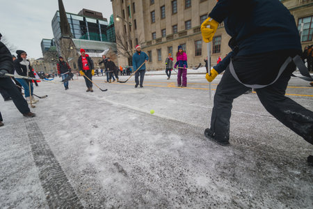 Ottawa, Ontario, Canada - February 12, 2022. People and kids playing hockey in front of parliament during Freedom Convoy Protest in Ottawa.のeditorial素材