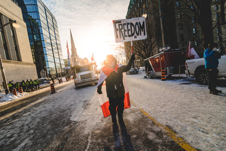 Ottawa, Ontario, Canada - February 13, 2022. Walking Protester on Wellington Street during Freedom Convoy Protest in Ottawa.のeditorial素材