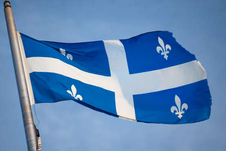 Canada, Quebec, provincial flag flying in the windの写真素材