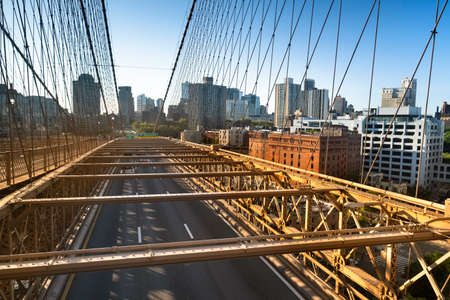 Traffic moves across the Brooklyn Bridge connecting Manhattan New York City over the East Riverの写真素材
