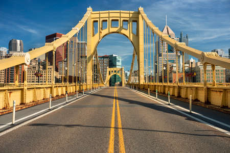 Traffic and people cross the Allegheny River on the Roberto Clemente Bridge in downtown Pittsburgh Pennsylvania USAの写真素材