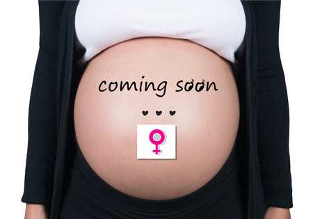 coming soon. pregnant woman with female symbol in front of her bellyの写真素材